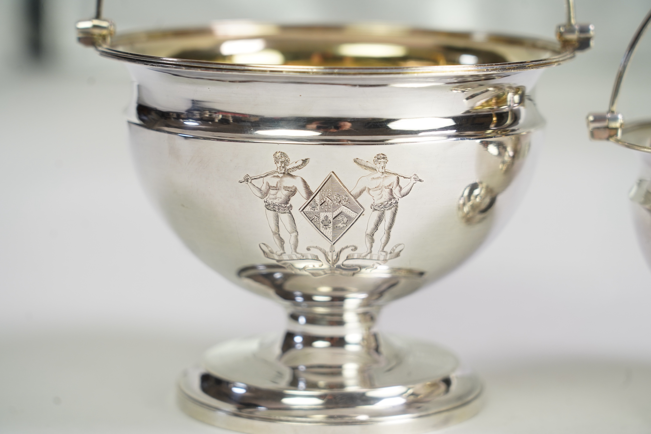 Two George III graduated silver pedestal sugar baskets, by James Darquits